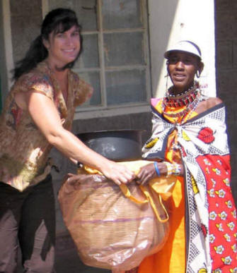 Karyn Ellis (left) helped distribute solar cookers, pots, and hay baskets in Kajiado as part of a training program funded by SCI and the Lift Up Africa organization