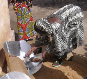 Mariam Toure proudly serves samples of her solar meal